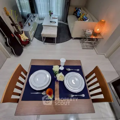 Stylish living room with dining area, modern decor, and musical instruments for a cozy urban lifestyle.