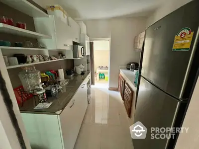 Charming compact kitchen with modern appliances and ample storage space