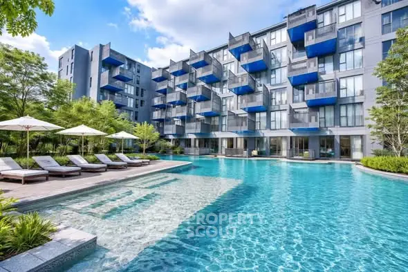 Luxurious apartment complex with stunning pool and modern balconies, perfect for upscale living.