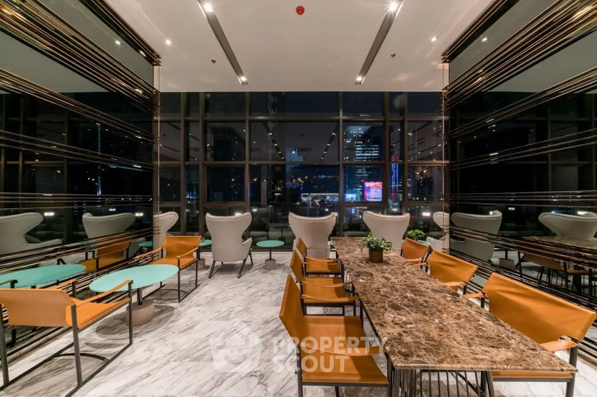 Luxurious modern lobby with elegant seating and city view, perfect for relaxation and social gatherings.