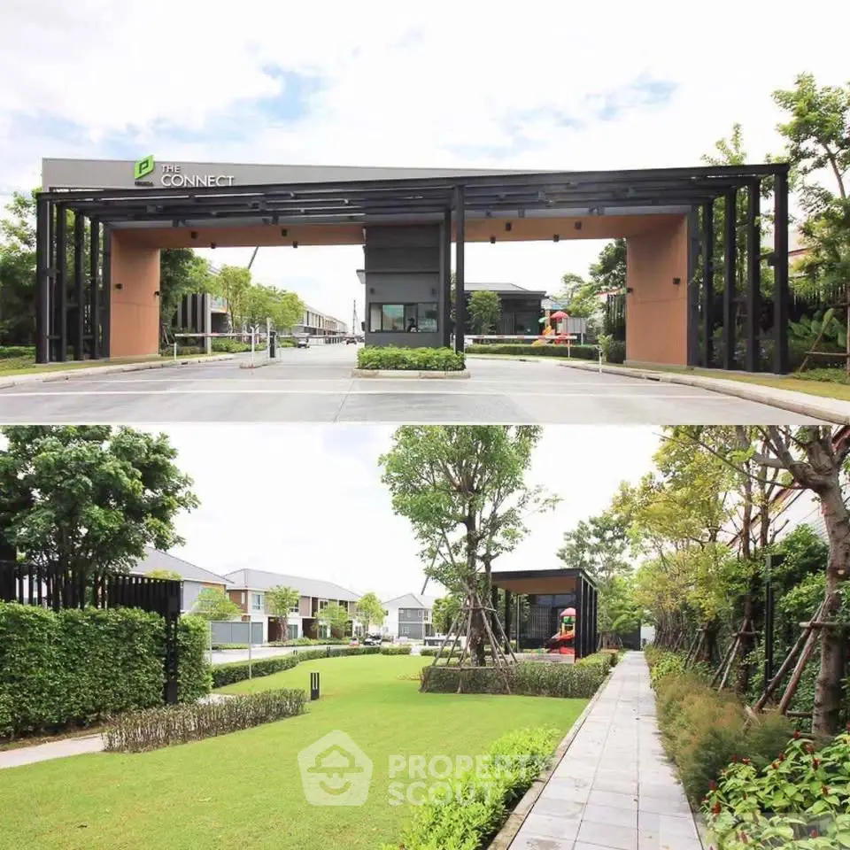 Modern gated community entrance with lush green landscaping and pathway.