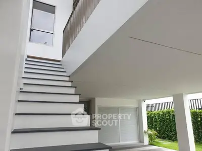 Modern white staircase in a contemporary home with garden view