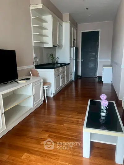 Charming apartment with sleek kitchen and cozy living area, perfect for modern urban living.
