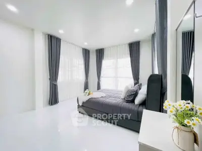 Spacious modern bedroom with elegant decor and natural light