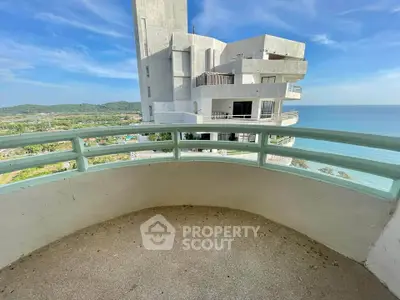 Stunning ocean view from a spacious balcony in a modern high-rise building.
