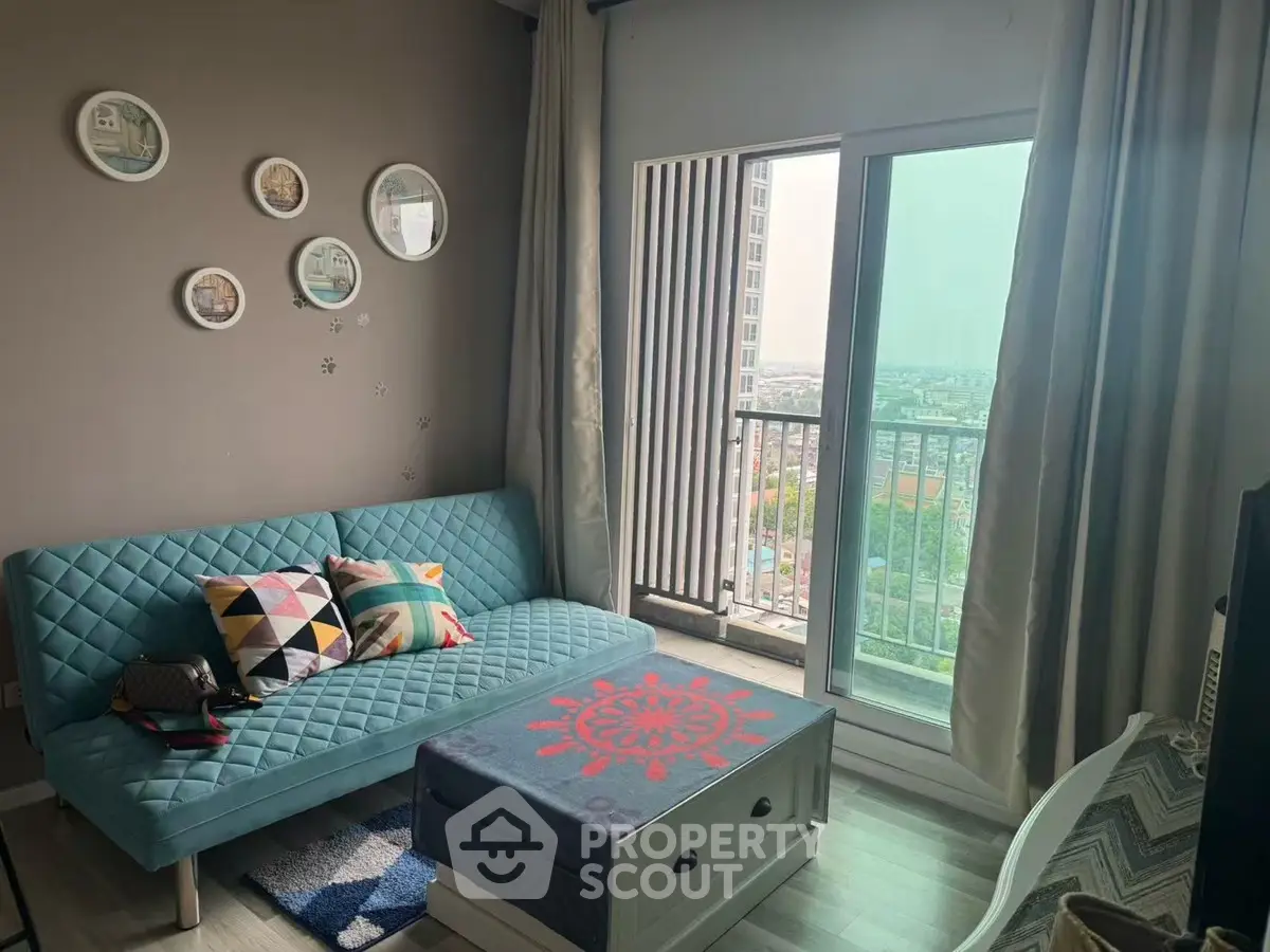 Chic living room with modern decor and balcony view in urban apartment.