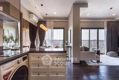 Modern open-plan living room with balcony view and stylish kitchen