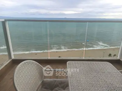 Stunning oceanfront balcony view with elegant seating, perfect for relaxation.