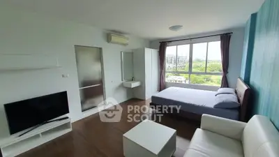 Spacious modern bedroom with large window and stylish furnishings
