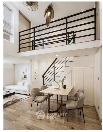 Stunning modern living room with mezzanine, elegant dining area, and stylish decor in open-concept space.