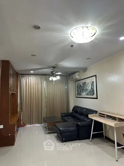 Spacious living room with modern furniture and elegant lighting in a stylish apartment.