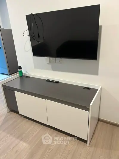 Modern living room with wall-mounted TV and sleek storage unit, perfect for contemporary homes.