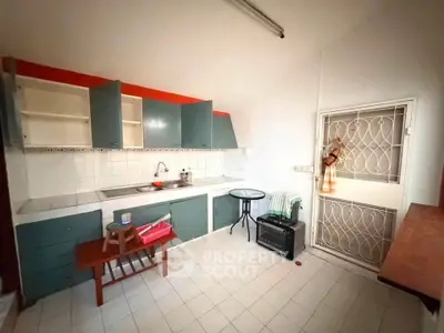 Charming kitchen with closed layout and ample storage in cozy apartment.