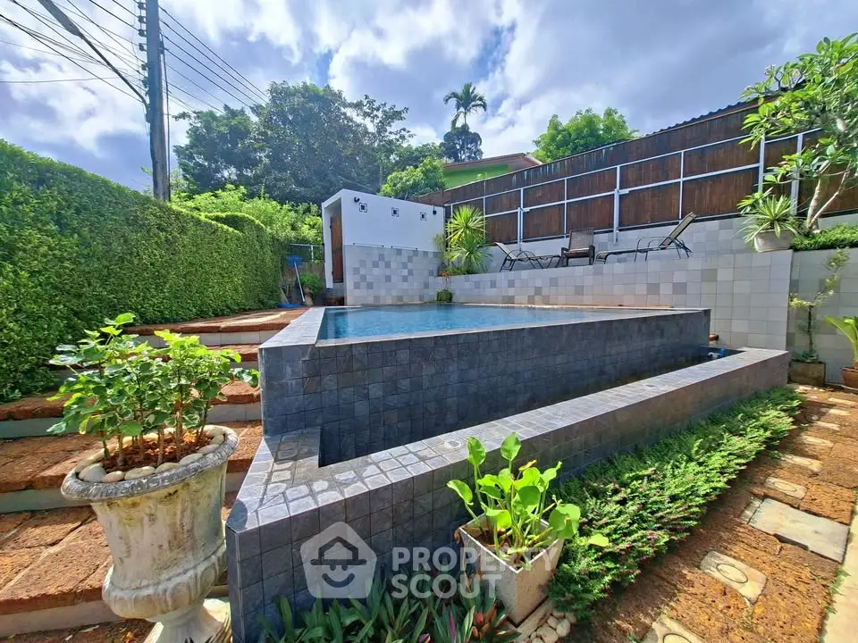 Stunning backyard with a modern pool and lush greenery, perfect for relaxation and outdoor entertainment.