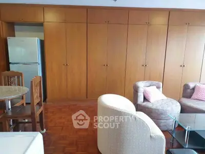 Spacious living room with elegant wooden cabinets and cozy seating area