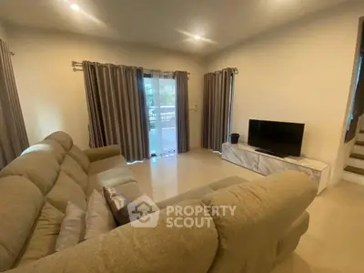 Spacious living room with cozy sofa and modern TV setup