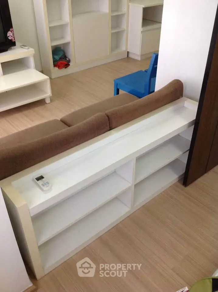 Modern living room with stylish furniture and built-in shelving, perfect for cozy urban living.