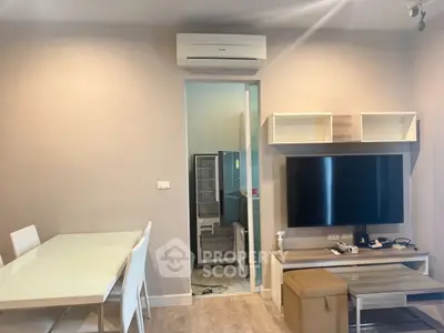 Modern living room with air conditioning and sleek furniture, featuring a dining area and wall-mounted TV.