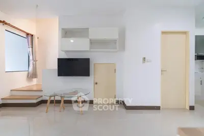 Modern living room with minimalist decor and wall-mounted TV