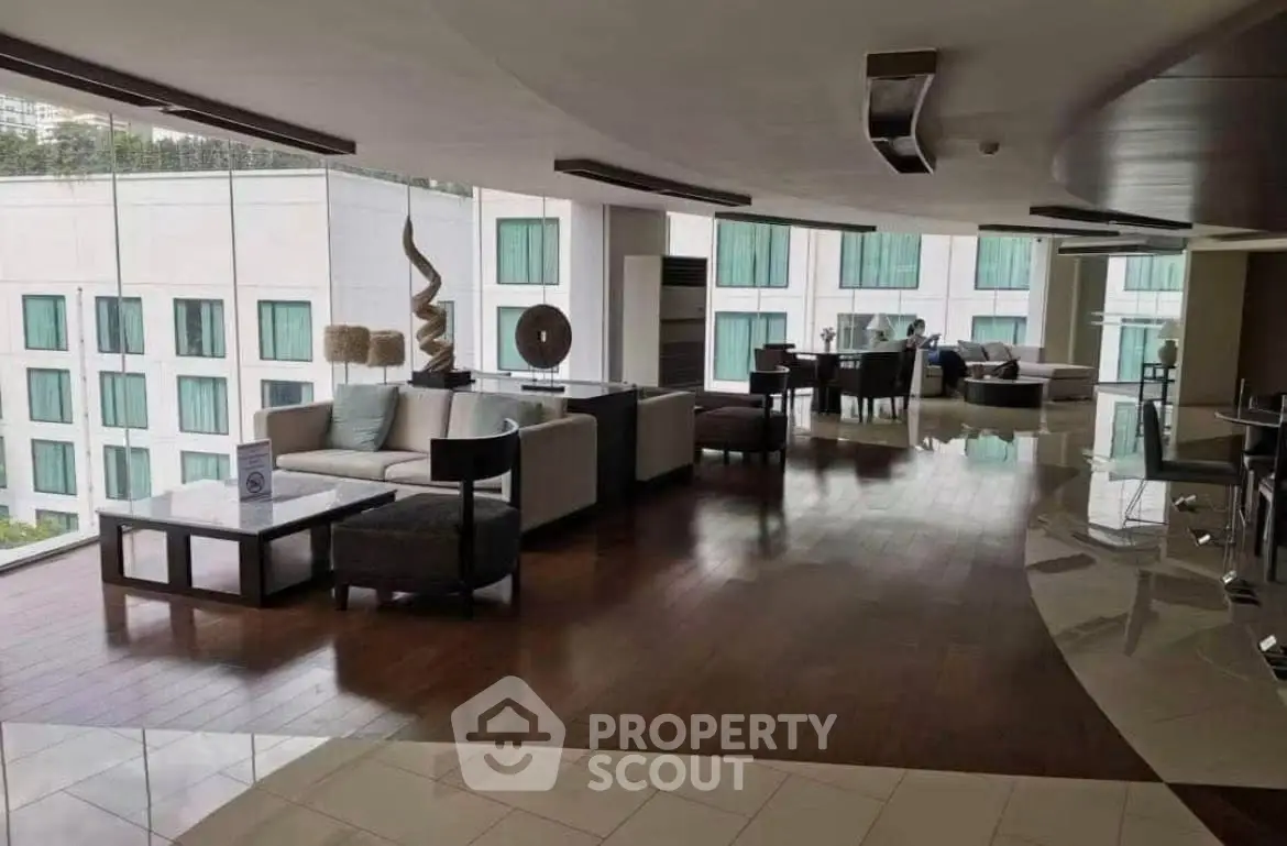 Luxurious modern living room with elegant decor and panoramic windows in a high-end apartment.