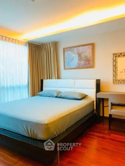 Elegant bedroom with modern decor and natural light in a stylish apartment.
