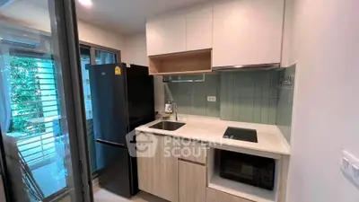 Modern kitchen with sleek appliances and open layout in a stylish apartment