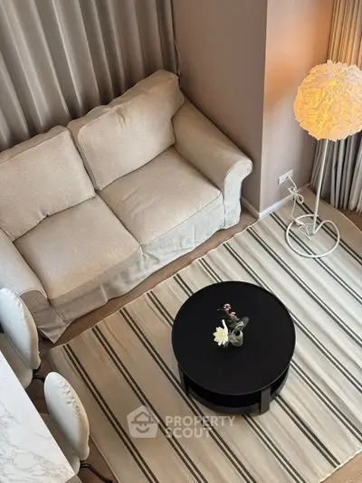 Modern living room with cozy beige sofa and stylish round coffee table
