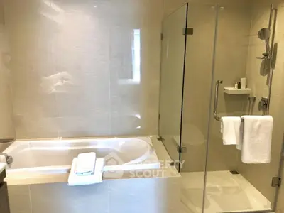 Luxurious bathroom with modern bathtub and glass shower enclosure