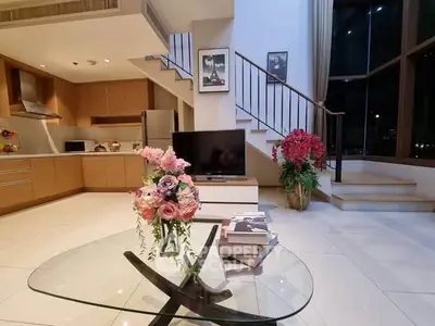 Spacious modern living room with elegant decor and open kitchen layout