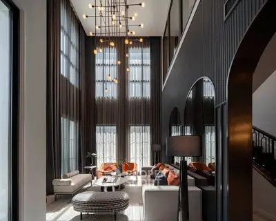 Luxurious double-height living room with modern decor and elegant lighting