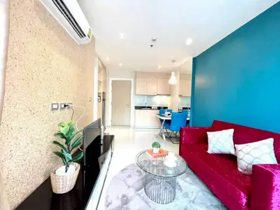 Stylish living room with vibrant red sofa and modern decor in a contemporary apartment.