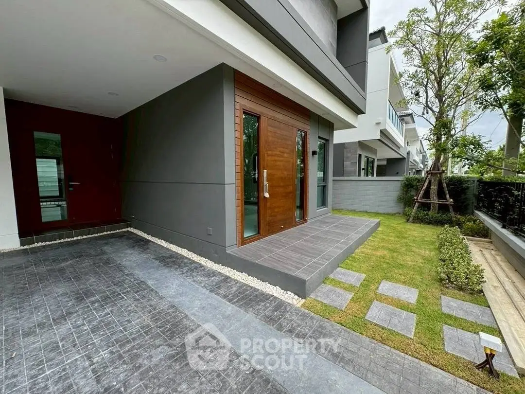 Modern house exterior with landscaped garden and spacious driveway