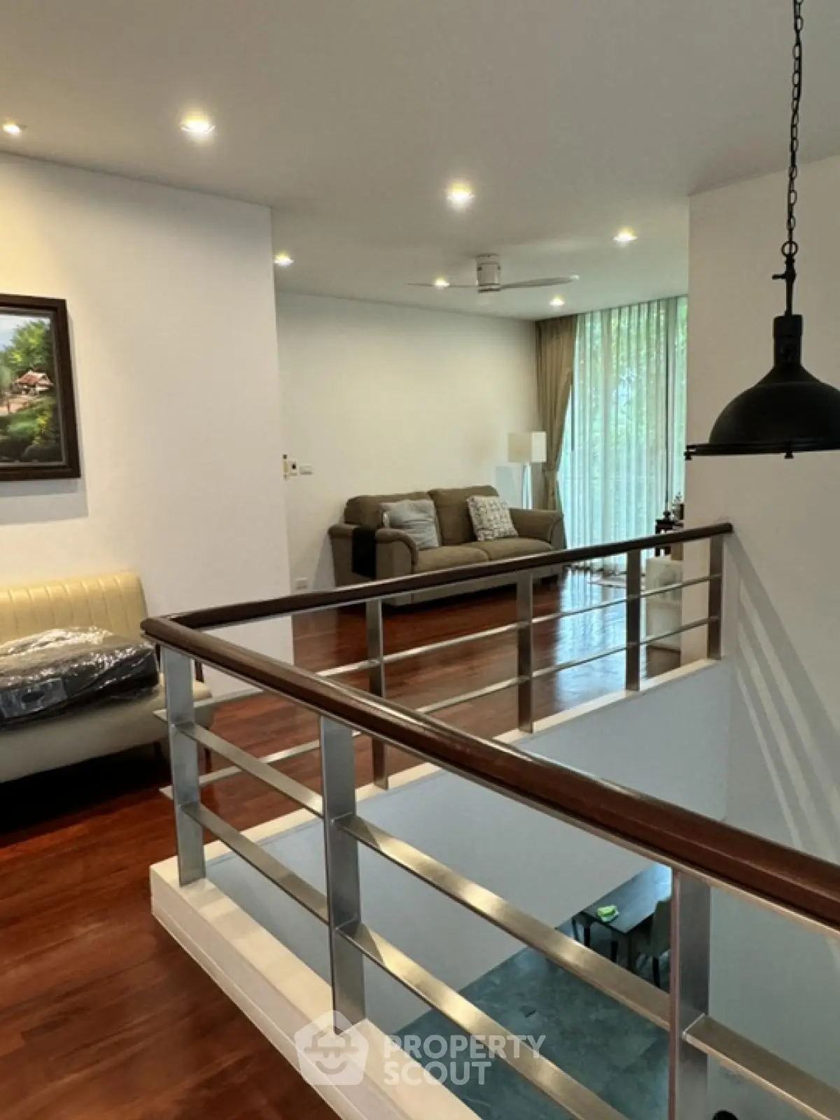 Modern duplex interior with stylish railing and cozy living area