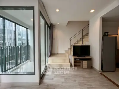 Modern duplex apartment with sleek staircase and balcony view