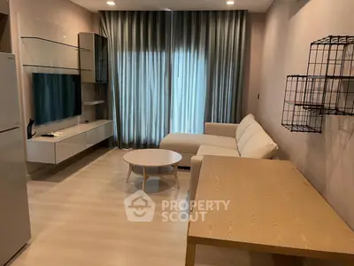 Modern living room with sleek furniture and natural light, perfect for relaxation and entertainment.