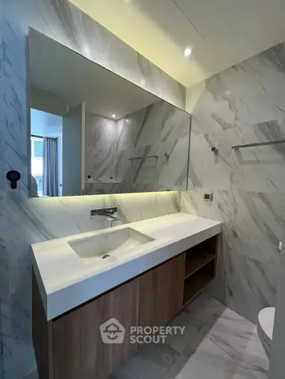 Modern bathroom with sleek marble walls and stylish vanity unit