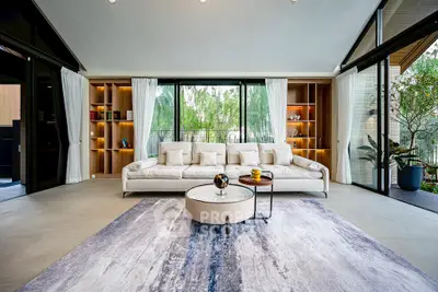 Luxurious living room with modern design, large windows, and elegant decor.