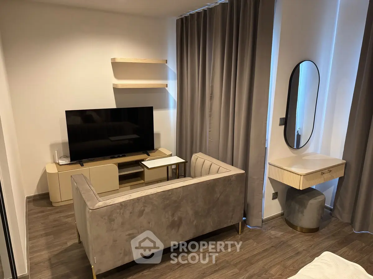 Modern living room with sleek furniture and large TV, perfect for relaxation.