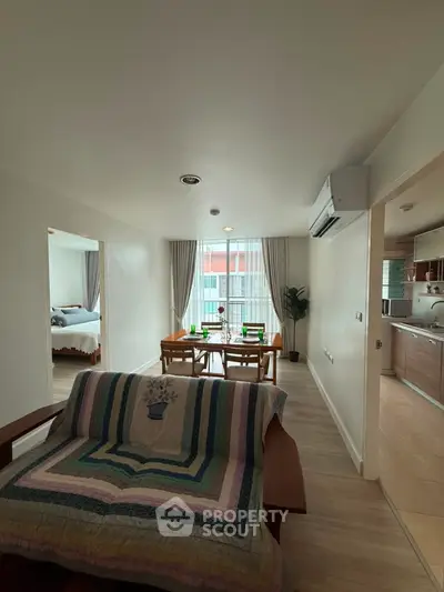 Spacious open-plan living and dining area with natural light and modern furnishings.
