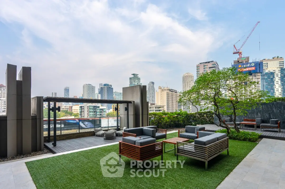 Stunning rooftop terrace with modern seating and city skyline view, perfect for urban living.