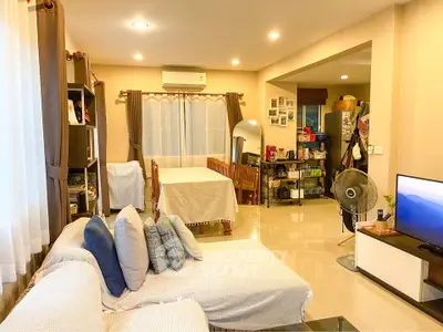 Spacious living room with modern decor and dining area in open layout apartment.