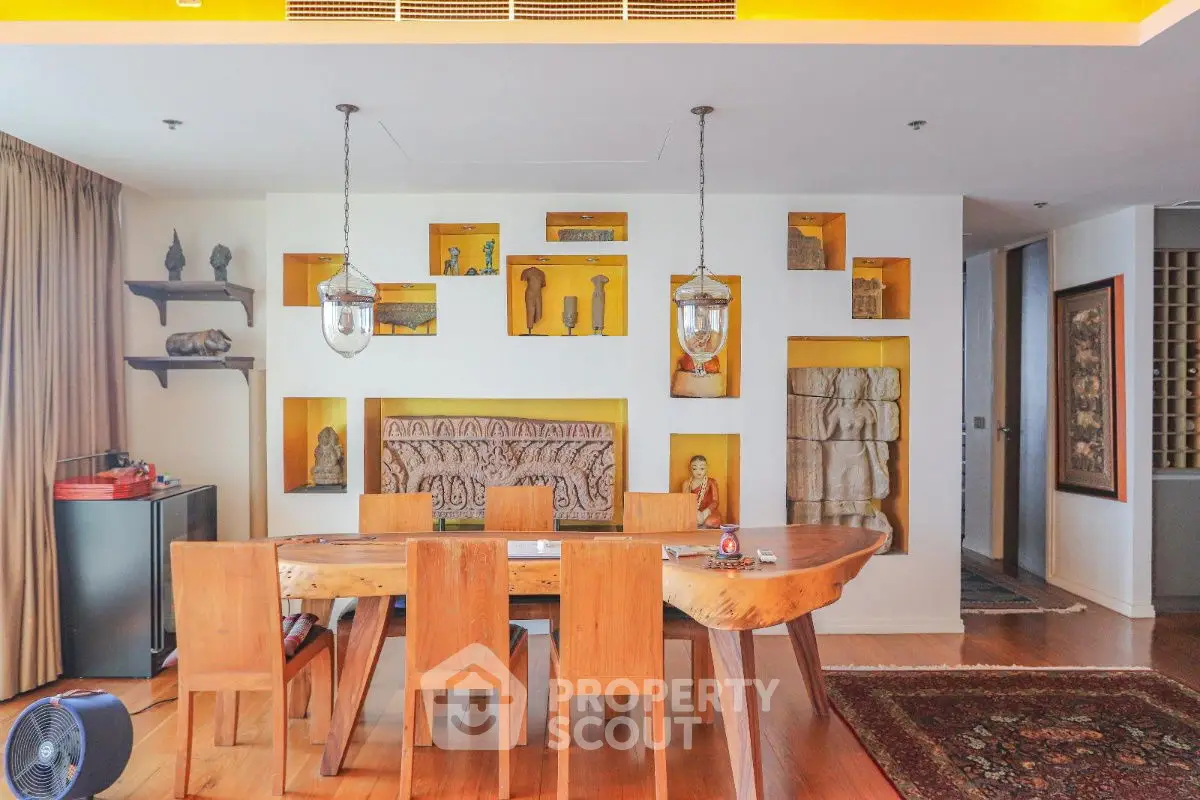 Elegant dining area with unique wooden table and artistic decor