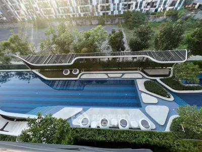 Luxurious modern swimming pool with stylish design and lush greenery in upscale residential complex.