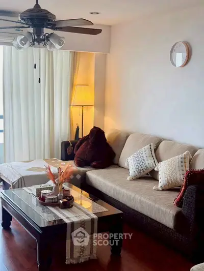 Cozy living room with plush sofa, elegant coffee table, and warm lighting