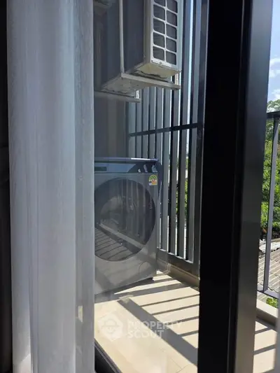 Modern balcony with washing machine and air conditioning unit, offering a practical outdoor space.