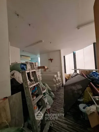Spacious storage room with construction materials and tools, ideal for renovation projects.