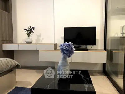 Modern bedroom with sleek TV setup and elegant decor