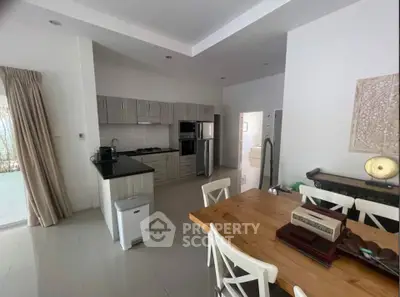 Spacious kitchen and dining area with modern appliances and elegant decor
