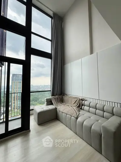 Modern living room with floor-to-ceiling windows and stunning city view