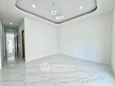Spacious modern living room with elegant ceiling lights and marble flooring
